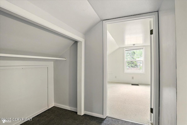 2527 Cottonwood St, Anchorage, AK 99508 - bonus room with dark carpet, vaulted ceiling, and baseboards