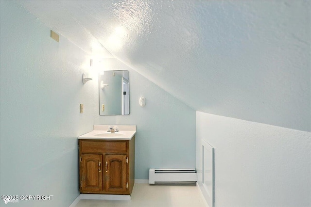 2527 Cottonwood St, Anchorage, AK 99508 - bathroom with baseboard heating, lofted ceiling, vanity, a textured ceiling, and baseboards