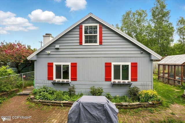 2527 Cottonwood St, Anchorage, AK 99508 - view of home's exterior featuring an exterior structure, an outdoor structure, and a chimney