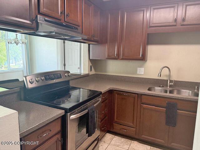 1008 Wildrose Ct, Anchorage, AK 99518 - kitchen featuring stainless steel electric range oven, a sink, light tile patterned floors, and under cabinet range hood