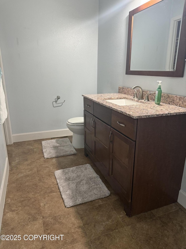 1008 Wildrose Ct, Anchorage, AK 99518 - bathroom featuring vanity, toilet, and baseboards