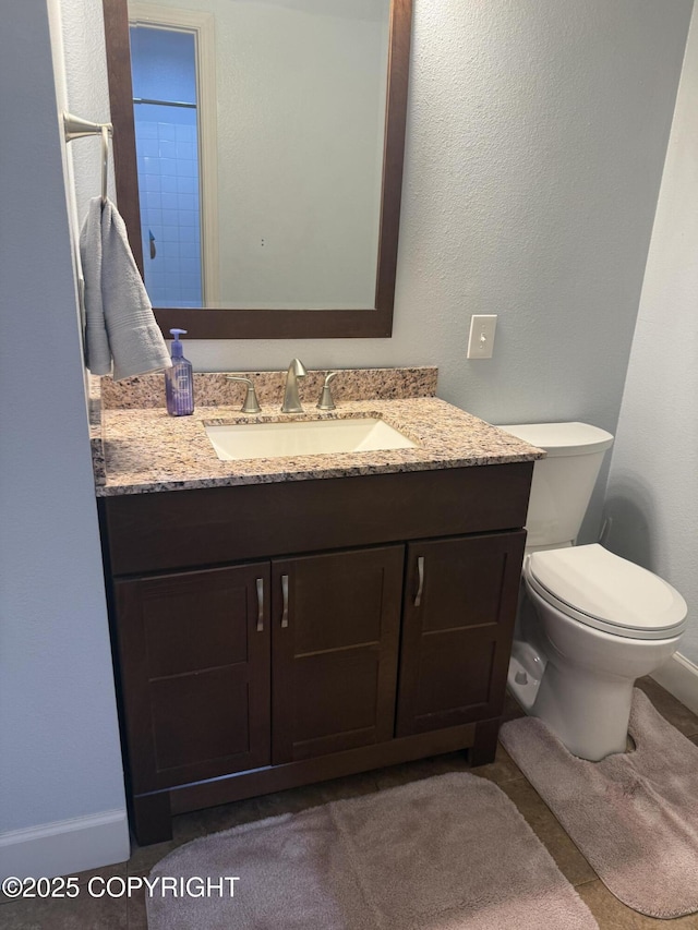 1008 Wildrose Ct, Anchorage, AK 99518 - bathroom featuring vanity, toilet, and baseboards