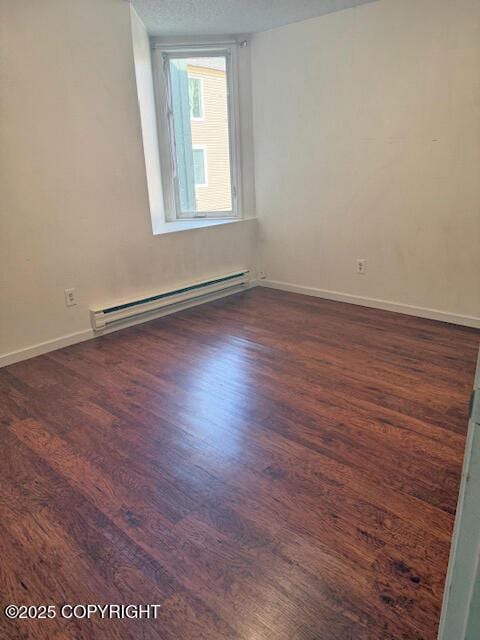 1008 Wildrose Ct, Anchorage, AK 99518 - spare room featuring baseboard heating, dark wood finished floors, and baseboards