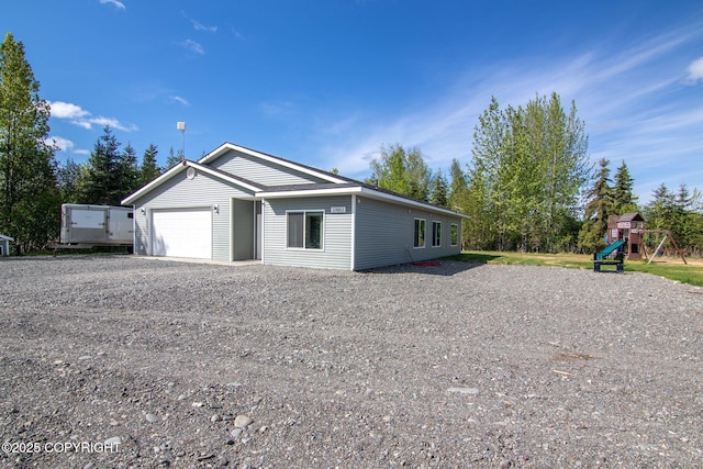 37653 Deville Rd, Soldotna, AK 99669 - view of front of property featuring a playground, gravel driveway, and an attached garage