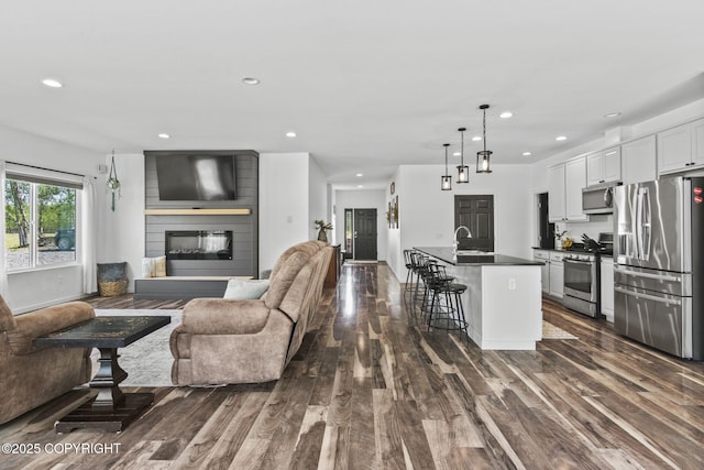 37653 Deville Rd, Soldotna, AK 99669 - living area with dark wood-style flooring, recessed lighting, and a fireplace