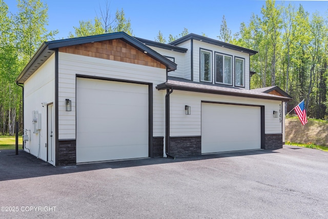 1645 N Vroman Dr, Palmer, AK 99645 - view of front of home with stone siding and a garage