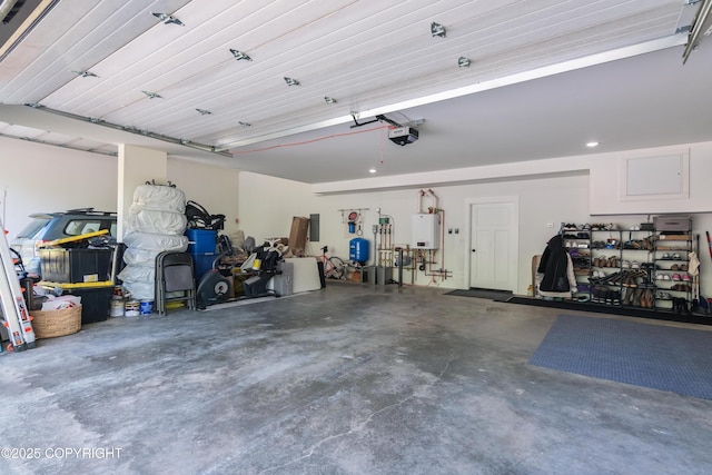 1645 N Vroman Dr, Palmer, AK 99645 - garage featuring tankless water heater and a garage door opener