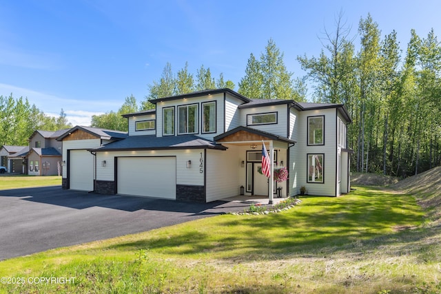 1645 N Vroman Dr, Palmer, AK 99645 - view of front facade featuring a front yard, driveway, and a garage