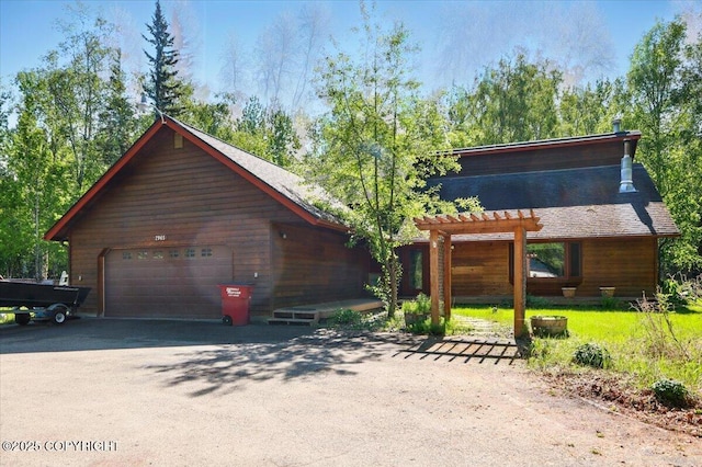 7965 S Settlers Bay Dr, Wasilla, AK 99623 - view of front of house with a garage, a pergola, and asphalt driveway