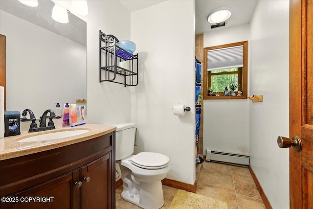 7965 S Settlers Bay Dr, Wasilla, AK 99623 - bathroom featuring a baseboard heating unit, toilet, vanity, and baseboards