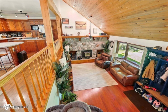 7965 S Settlers Bay Dr, Wasilla, AK 99623 - living area with lofted ceiling, wood finished floors, and a fireplace