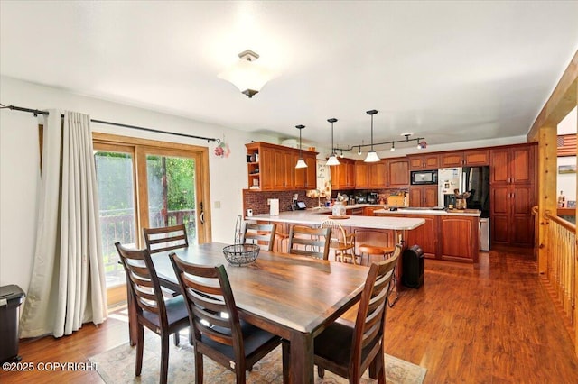 7965 S Settlers Bay Dr, Wasilla, AK 99623 - dining area featuring rail lighting and dark wood-type flooring
