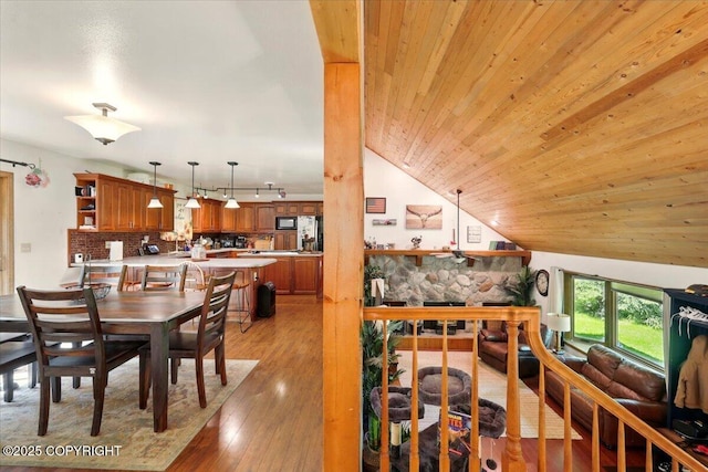 7965 S Settlers Bay Dr, Wasilla, AK 99623 - dining space featuring light wood-type flooring, wood ceiling, track lighting, and lofted ceiling