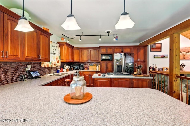 7965 S Settlers Bay Dr, Wasilla, AK 99623 - kitchen featuring a sink, appliances with stainless steel finishes, light countertops, decorative light fixtures, and brown cabinets