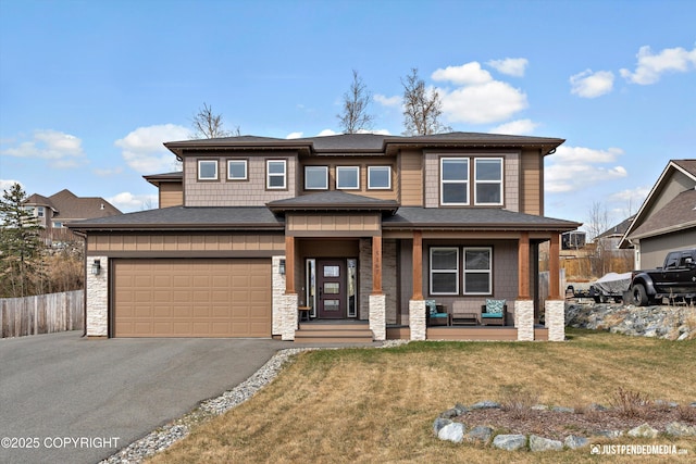 5167 E Henhouse Loop, Wasilla, AK 99654 - prairie-style house featuring asphalt driveway, a porch, stone siding, and a shingled roof