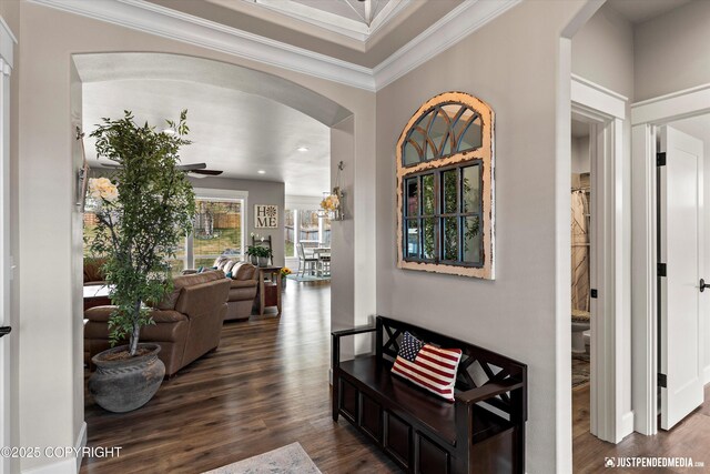 5167 E Henhouse Loop, Wasilla, AK 99654 - hallway with arched walkways, dark wood finished floors, crown molding, and recessed lighting