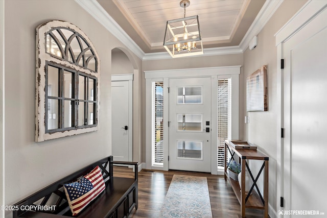 5167 E Henhouse Loop, Wasilla, AK 99654 - entryway with a raised ceiling, dark wood-style flooring, a chandelier, arched walkways, and crown molding
