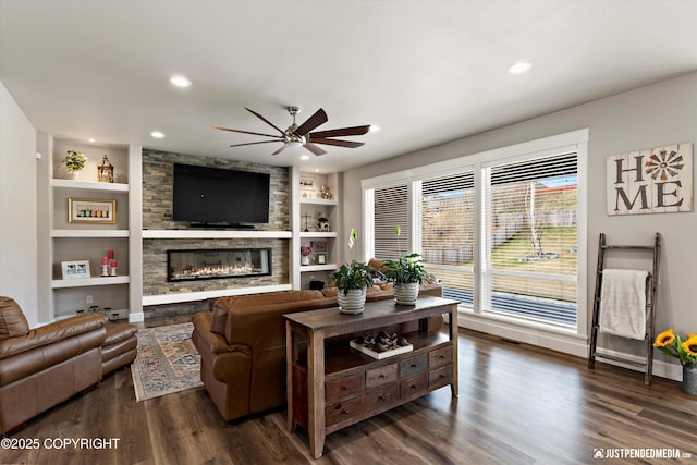 5167 E Henhouse Loop, Wasilla, AK 99654 - living area with a ceiling fan, built in features, dark wood-type flooring, a fireplace, and recessed lighting