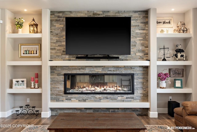 5167 E Henhouse Loop, Wasilla, AK 99654 - living area with wood finished floors, built in shelves, a stone fireplace, and baseboards
