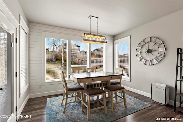 5167 E Henhouse Loop, Wasilla, AK 99654 - dining room featuring baseboards, dark wood finished floors, and wooden walls