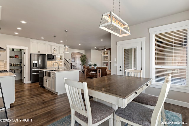 5167 E Henhouse Loop, Wasilla, AK 99654 - dining room featuring arched walkways, dark wood-type flooring, a ceiling fan, recessed lighting, and baseboards