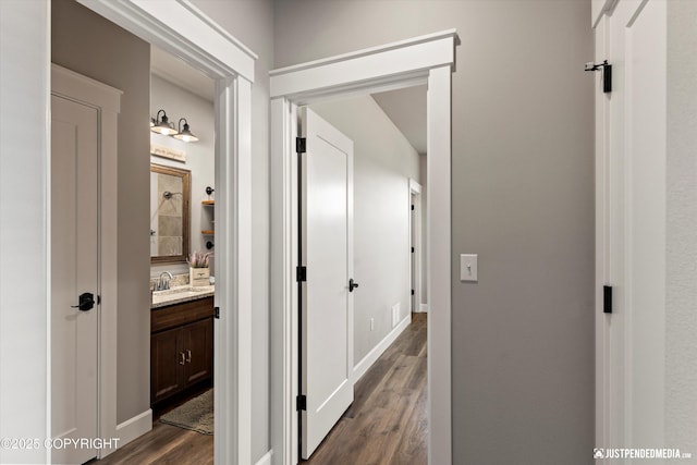 5167 E Henhouse Loop, Wasilla, AK 99654 - hall with dark wood-style floors, a sink, and baseboards