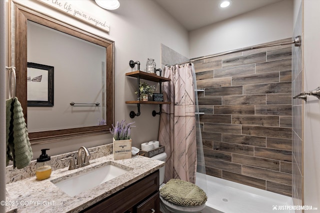 5167 E Henhouse Loop, Wasilla, AK 99654 - bathroom featuring vanity, tiled shower, toilet, and recessed lighting