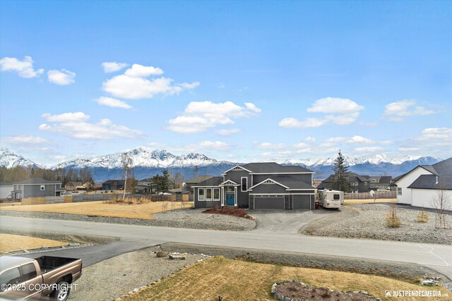 5167 E Henhouse Loop, Wasilla, AK 99654 - view of front facade featuring a mountain view, an attached garage, asphalt driveway, and a residential view