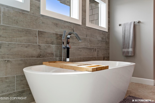 5167 E Henhouse Loop, Wasilla, AK 99654 - full bathroom with a freestanding bath, a sink, and baseboards