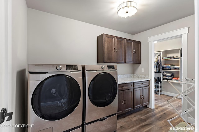 5167 E Henhouse Loop, Wasilla, AK 99654 - laundry area featuring cabinet space, washer and dryer, wood finished floors, and baseboards