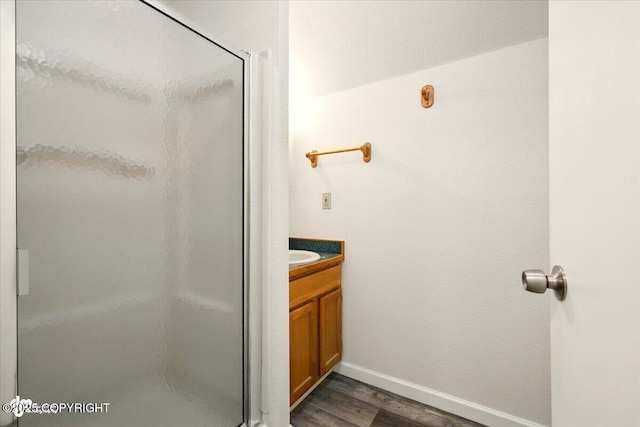 14045 W Willow Fishhook Rd, Willow, AK 99688 - bathroom featuring a shower stall, wood finished floors, vanity, and baseboards