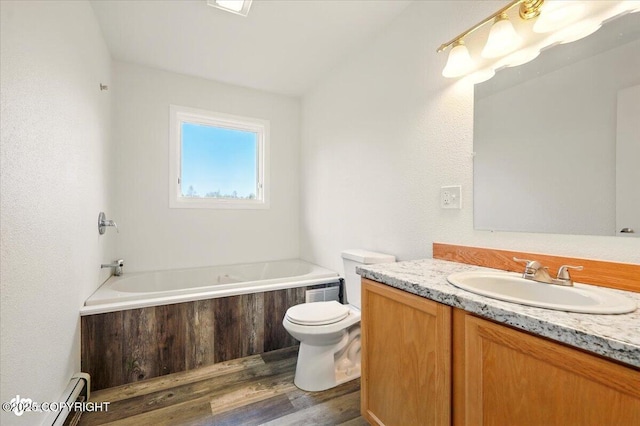 14045 W Willow Fishhook Rd, Willow, AK 99688 - full bath with a baseboard heating unit, vanity, a garden tub, toilet, and wood finished floors