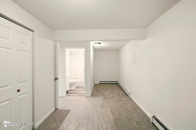 14045 W Willow Fishhook Rd, Willow, AK 99688 - hallway with light carpet, a baseboard heating unit, and baseboards