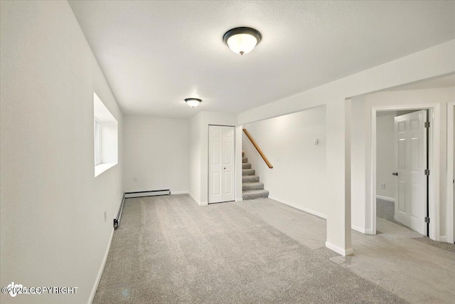 14045 W Willow Fishhook Rd, Willow, AK 99688 - basement featuring carpet flooring, stairway, baseboards, and a baseboard heating unit