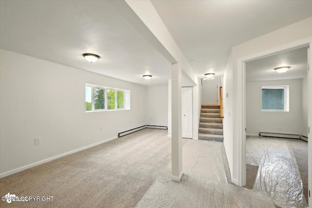 14045 W Willow Fishhook Rd, Willow, AK 99688 - below grade area featuring a baseboard radiator, stairway, light carpet, baseboards, and a textured ceiling