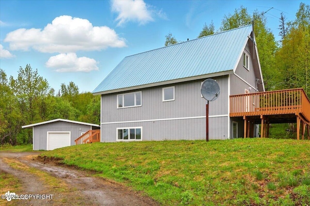 14045 W Willow Fishhook Rd, Willow, AK 99688 - view of side of property with a detached garage, a deck, an outbuilding, metal roof, and a lawn