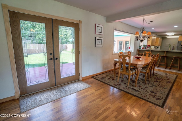 2503 Cedar St, Seward, AK 99664 - dining room featuring wood finished floors, french doors, baseboards, a chandelier, and recessed lighting