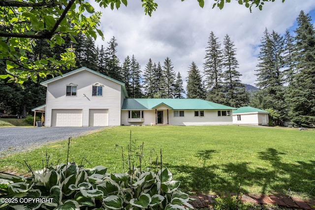 2503 Cedar St, Seward, AK 99664 - view of front facade featuring a garage, gravel driveway, a front yard, and metal roof