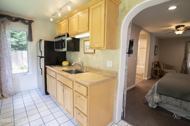 2503 Cedar St, Seward, AK 99664 - kitchen featuring stainless steel microwave, light brown cabinets, a sink, ceiling fan, and light countertops
