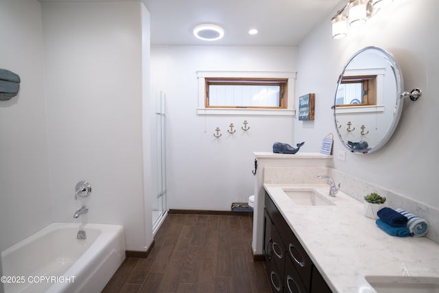 2503 Cedar St, Seward, AK 99664 - bathroom with double vanity, a bathtub, a shower, wood finished floors, and toilet