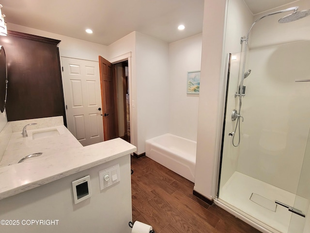 2503 Cedar St, Seward, AK 99664 - full bath featuring wood finished floors, a stall shower, vanity, a garden tub, and recessed lighting
