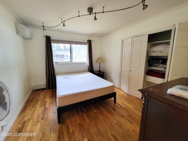 2503 Cedar St, Seward, AK 99664 - bedroom featuring a wall mounted AC, ornamental molding, a baseboard heating unit, light wood-type flooring, and rail lighting