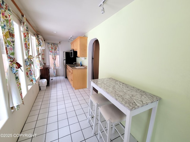 2503 Cedar St, Seward, AK 99664 - kitchen with light brown cabinets, light tile patterned flooring, light countertops, a sink, and track lighting