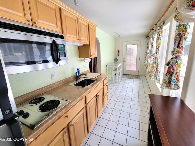2503 Cedar St, Seward, AK 99664 - kitchen with stainless steel microwave, a sink, light tile patterned flooring, electric stovetop, and light brown cabinets