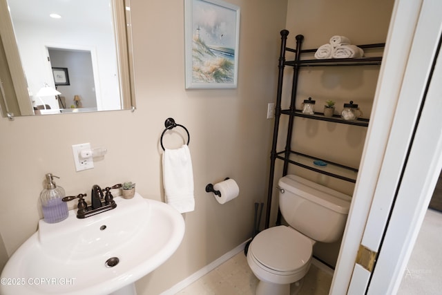 2503 Cedar St, Seward, AK 99664 - bathroom featuring a sink, toilet, and baseboards