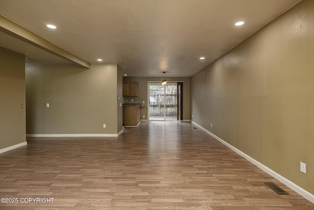 4012 Reka Dr # G5, Anchorage, AK 99508 - unfurnished living room with wood finished floors, baseboards, and recessed lighting