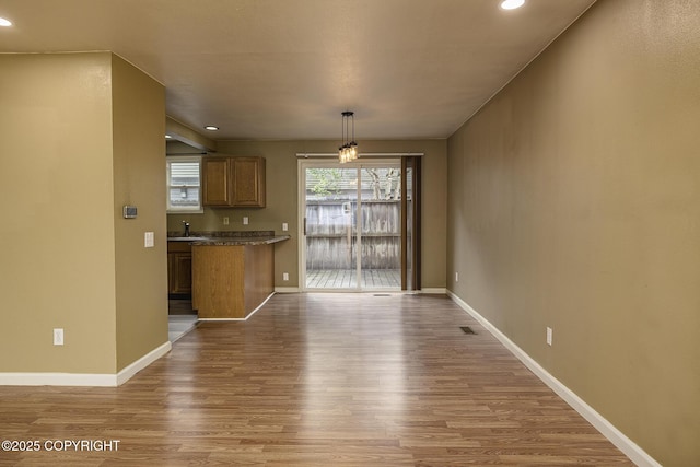 4012 Reka Dr # G5, Anchorage, AK 99508 - kitchen featuring a sink, wood finished floors, baseboards, recessed lighting, and brown cabinets