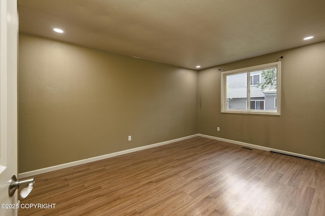 4012 Reka Dr # G5, Anchorage, AK 99508 - unfurnished room featuring wood finished floors, baseboards, and recessed lighting