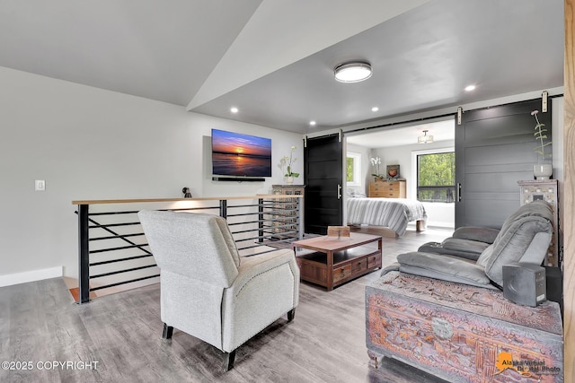 16111 E Nosey Ave, Talkeetna, AK 99676 - living area with wood finished floors, recessed lighting, a barn door, and vaulted ceiling
