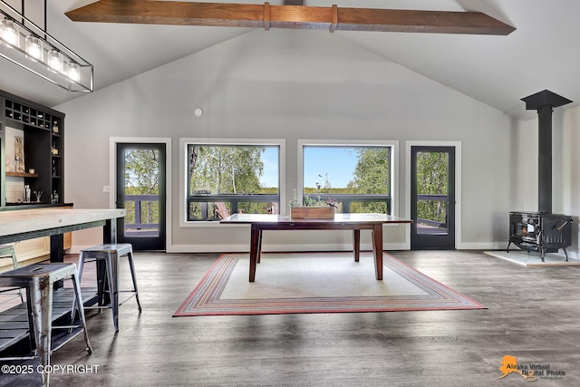 16111 E Nosey Ave, Talkeetna, AK 99676 - dining space featuring high vaulted ceiling, plenty of natural light, a wood stove, beamed ceiling, and baseboards